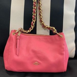 Beautiful pink COACH bag with gold accents.